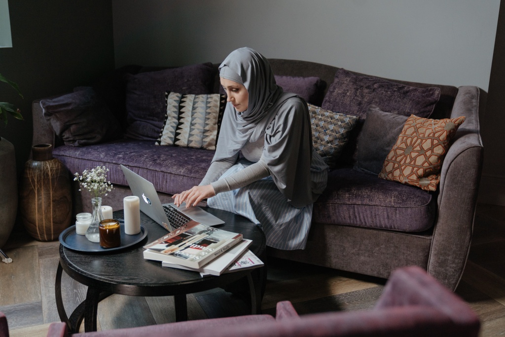 A woman with hijab working on the computer