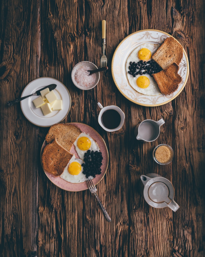 A breakfast with eggs, blueberries, and coffee