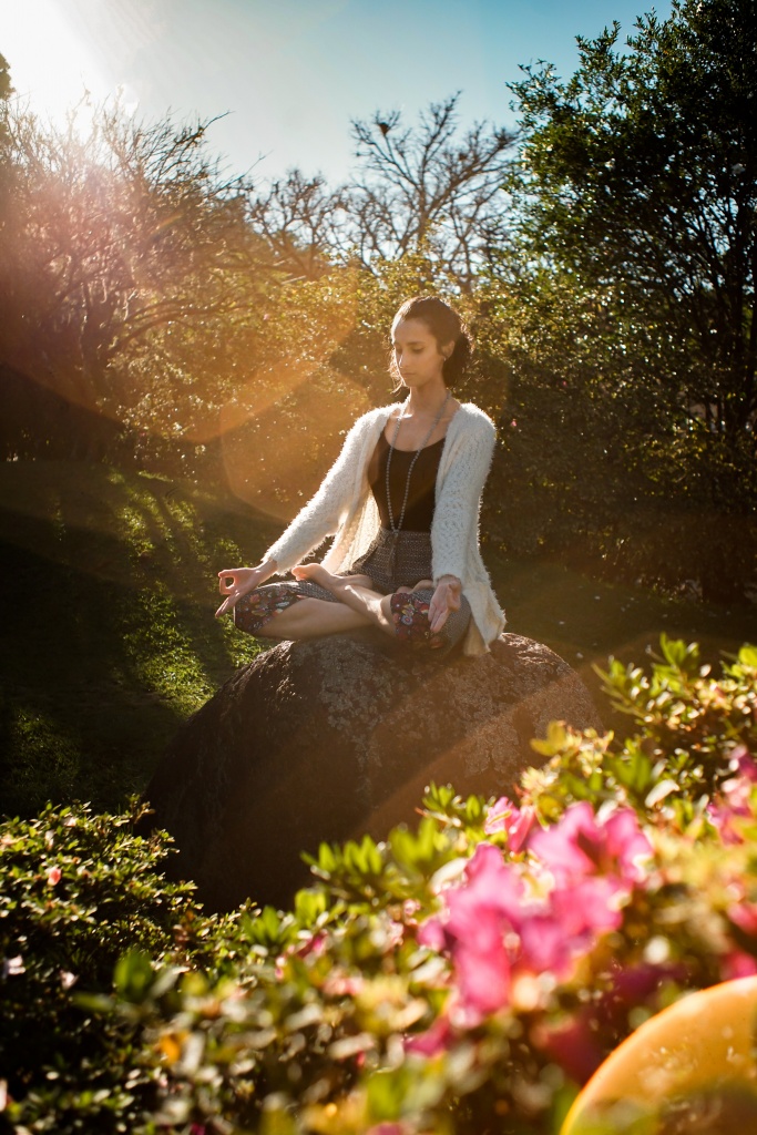 A lady meditating out in nature
