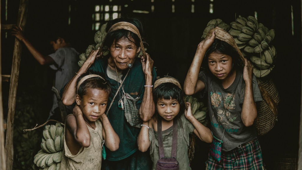 Group of girls holding bunches of bananas